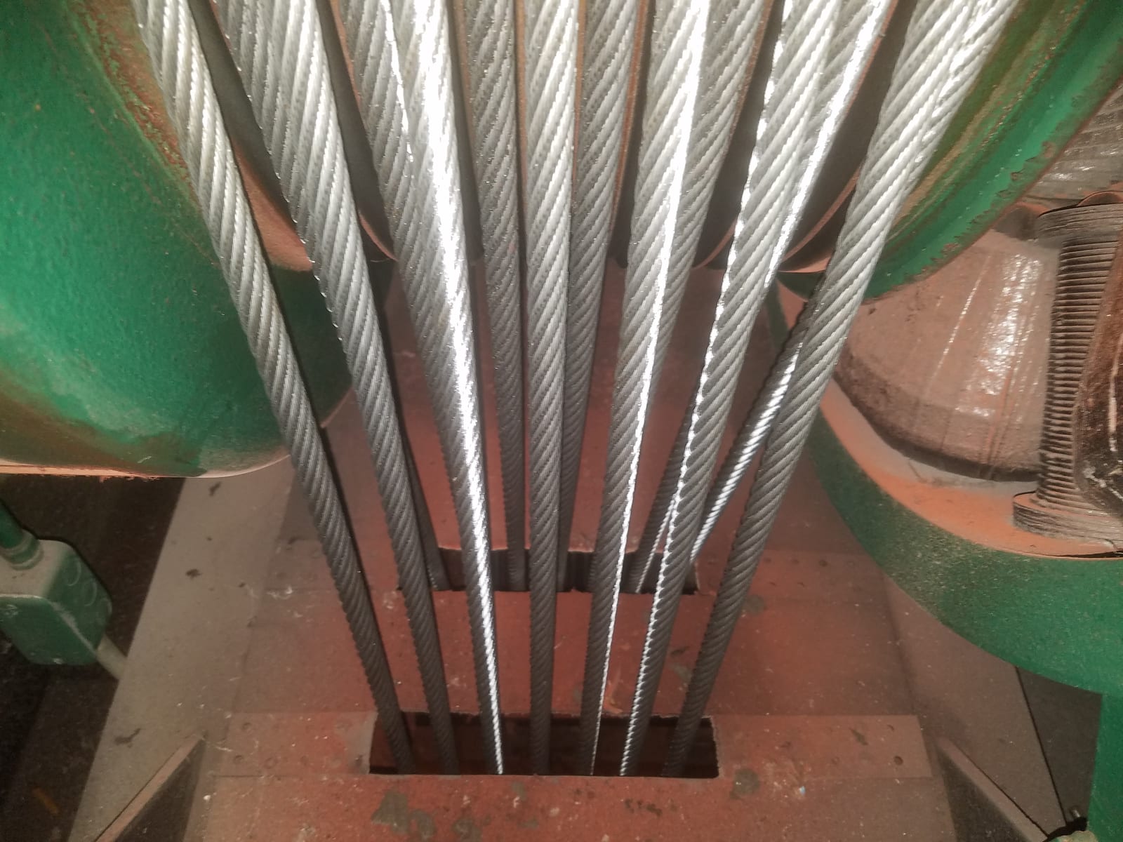 New suspension cables (hoist ropes) running over an elevator drive machine sheave